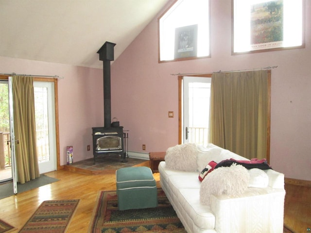 14770 Touve Rd, Herbster, WI 54844 - living room featuring a wood stove, wood finished floors, and high vaulted ceiling