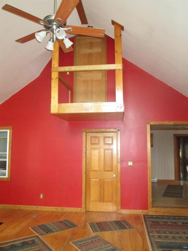 interior space with high vaulted ceiling, wood-type flooring, and ceiling fan