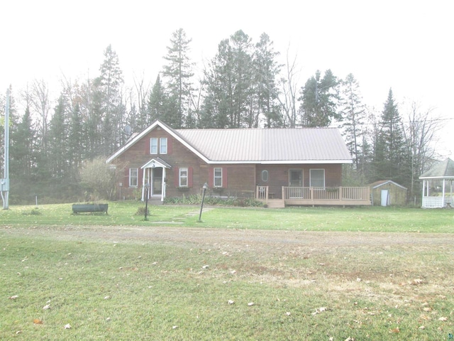 ranch-style home featuring a storage shed and a front yard