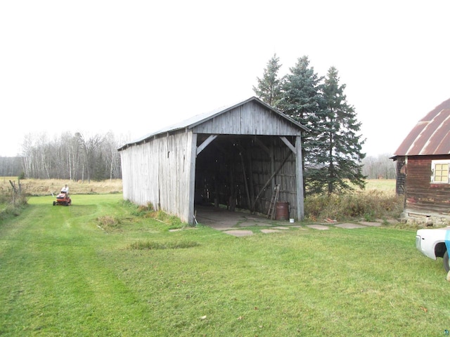 view of outbuilding featuring a lawn