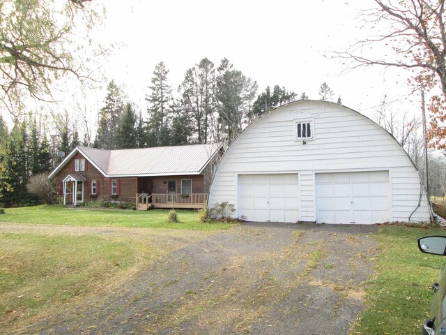14770 Touve Rd, Herbster, WI 54844 - view of front of property featuring a front yard, a garage, and metal roof