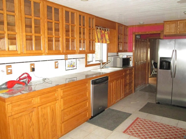 14770 Touve Rd, Herbster, WI 54844 - kitchen with appliances with stainless steel finishes, a sink, glass insert cabinets, brown cabinets, and light tile patterned floors