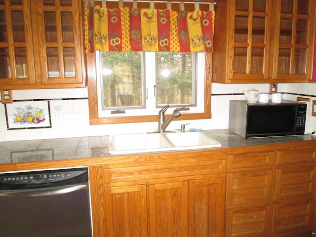 14770 Touve Rd, Herbster, WI 54844 - kitchen with stainless steel dishwasher, black microwave, a sink, glass insert cabinets, and brown cabinetry