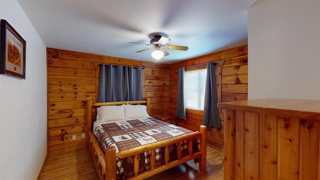 331 Hilltop Ct, Warrens, Warrens, WI 54666 - bedroom featuring wood walls, wood finished floors, and a ceiling fan