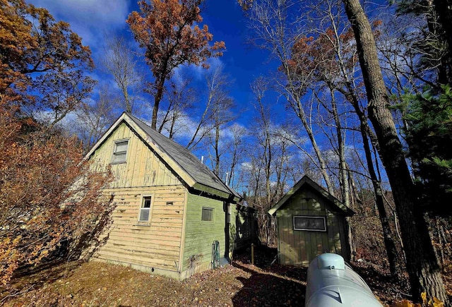 view of side of property with an outbuilding