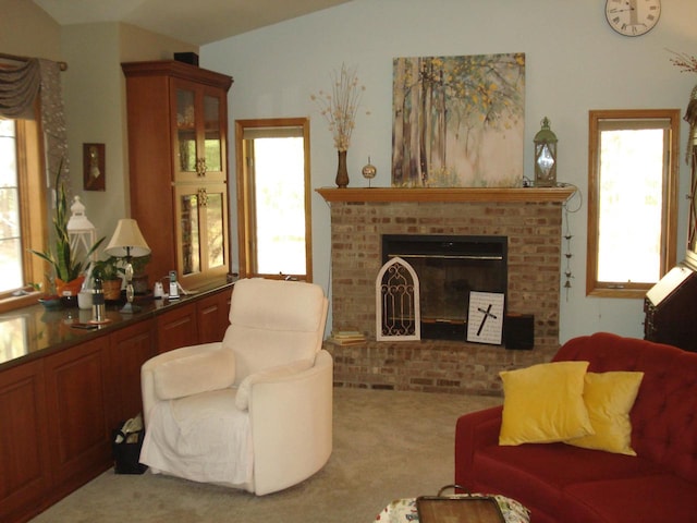 sitting room with lofted ceiling, carpet flooring, and a brick fireplace