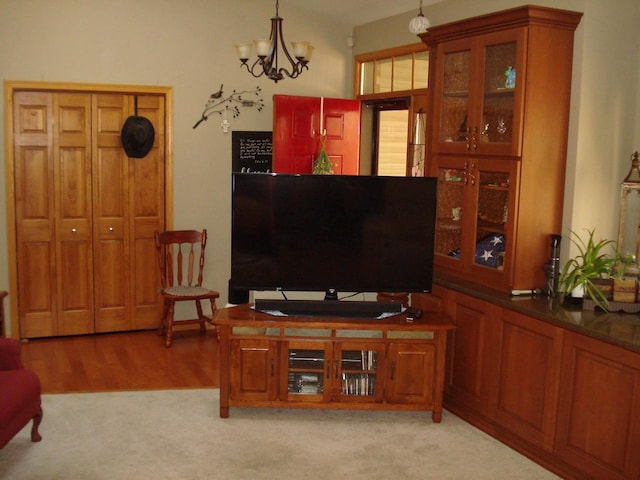 living room with light carpet and a notable chandelier