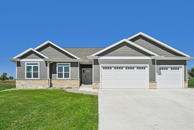 craftsman-style house featuring a front lawn and a garage