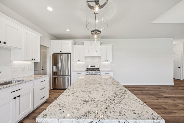 kitchen featuring hanging light fixtures, a kitchen island, appliances with stainless steel finishes, dark hardwood / wood-style flooring, and white cabinetry