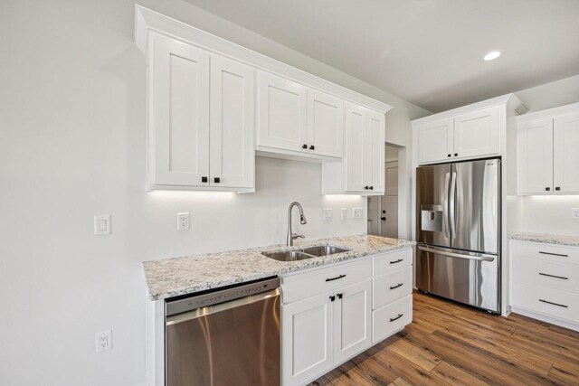 kitchen featuring sink, white cabinets, stainless steel appliances, and dark hardwood / wood-style floors