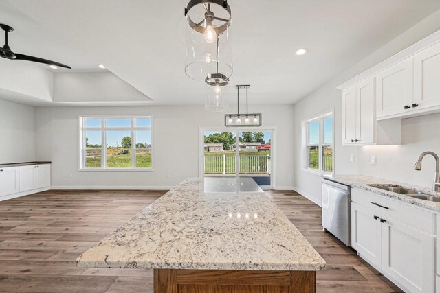 kitchen featuring stainless steel dishwasher, sink, a center island, and a wealth of natural light