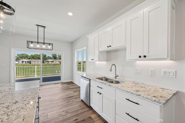 kitchen with stainless steel dishwasher, light hardwood / wood-style flooring, white cabinetry, and sink