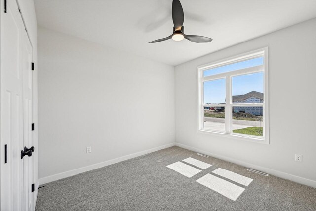 unfurnished bedroom featuring carpet floors and ceiling fan