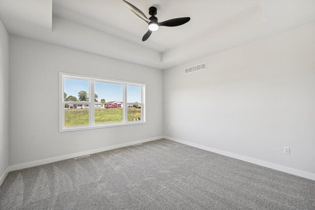 spare room featuring carpet and ceiling fan