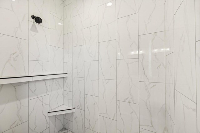 bathroom with tiled shower