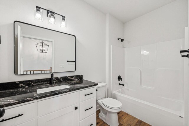 full bathroom with toilet, vanity, wood-type flooring, and shower / bath combination