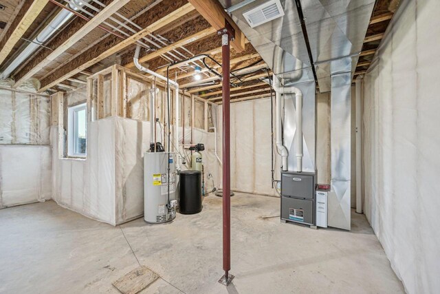 basement featuring heating unit and water heater