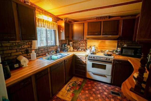 kitchen with backsplash, a textured ceiling, high end stainless steel range, wooden counters, and sink