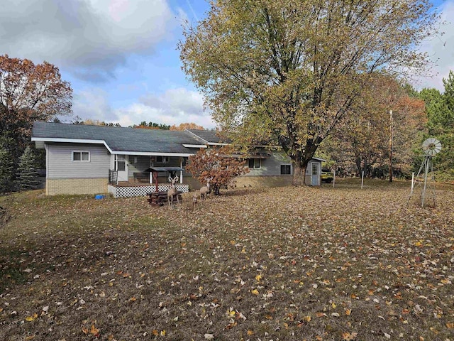 back of property with a wooden deck