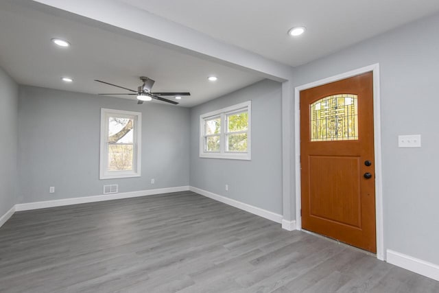 foyer with a wealth of natural light, light hardwood / wood-style flooring, and ceiling fan