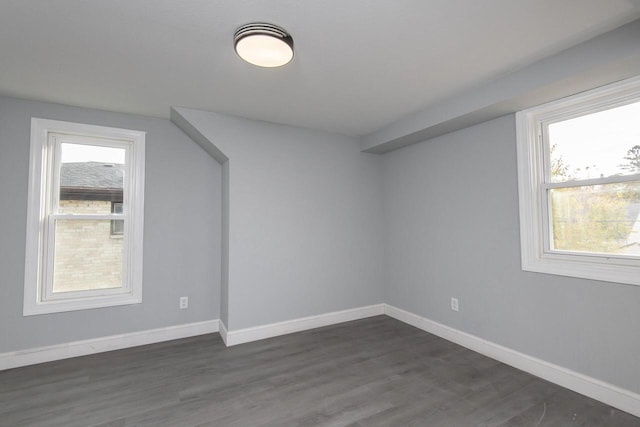 bonus room with dark hardwood / wood-style floors