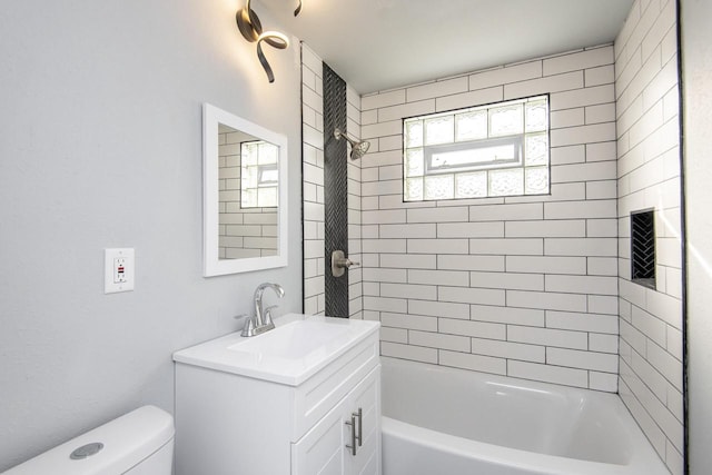 full bathroom with vanity, toilet, and tiled shower / bath combo