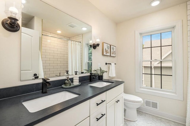 bathroom featuring vanity, a shower with curtain, and toilet