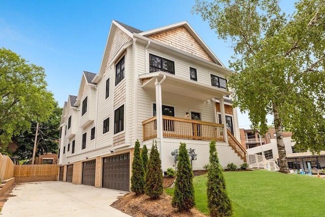 exterior space with a porch, a front lawn, and a garage