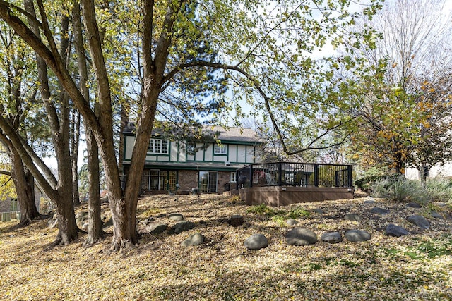 rear view of property featuring a deck