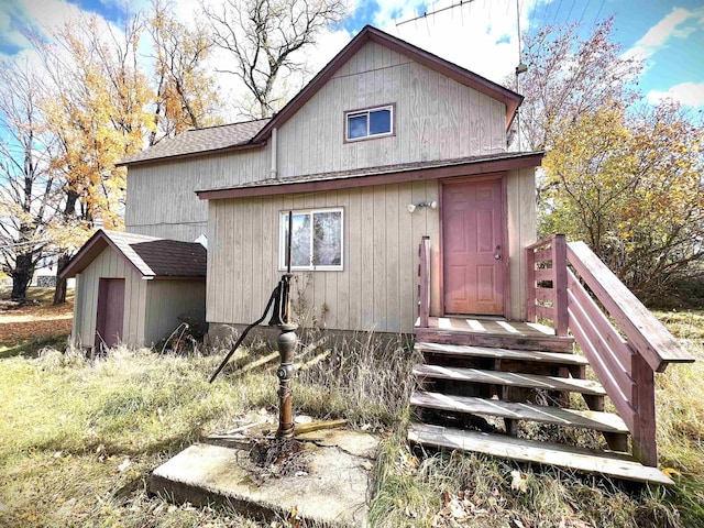 back of property with a shed