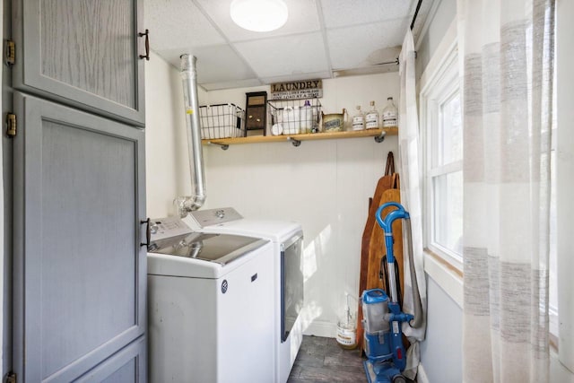 clothes washing area featuring dark wood-type flooring and washer and dryer