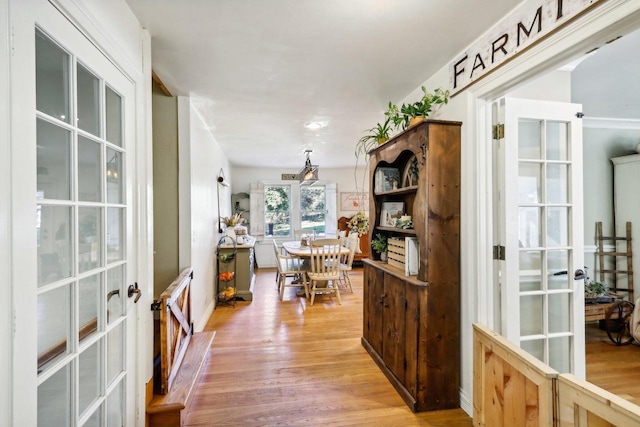 interior space with french doors and light wood-type flooring