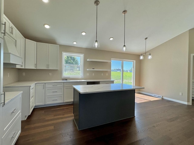 kitchen featuring pendant lighting, white cabinetry, dark hardwood / wood-style floors, and a healthy amount of sunlight