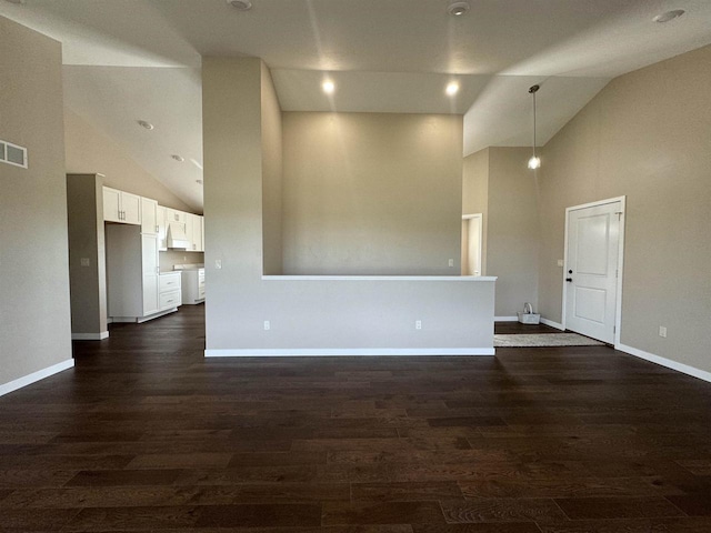 unfurnished living room featuring high vaulted ceiling and dark hardwood / wood-style flooring