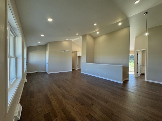 empty room with dark hardwood / wood-style floors and high vaulted ceiling