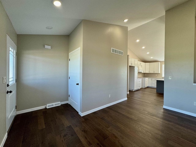 interior space with high vaulted ceiling and dark hardwood / wood-style floors