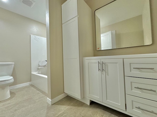 bathroom with vanity, toilet, and a washtub