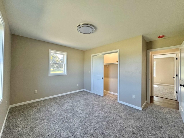 unfurnished bedroom featuring carpet and a closet