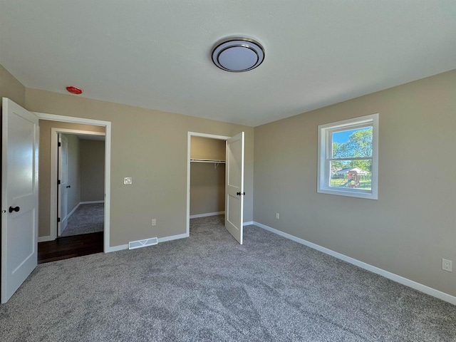 unfurnished bedroom with a closet and carpet floors