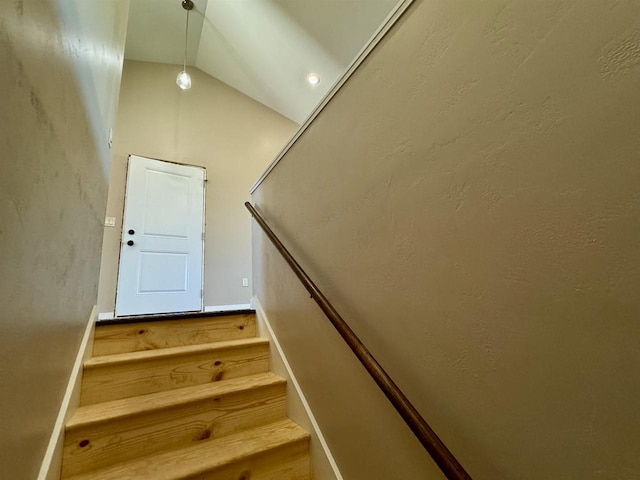 stairway with lofted ceiling