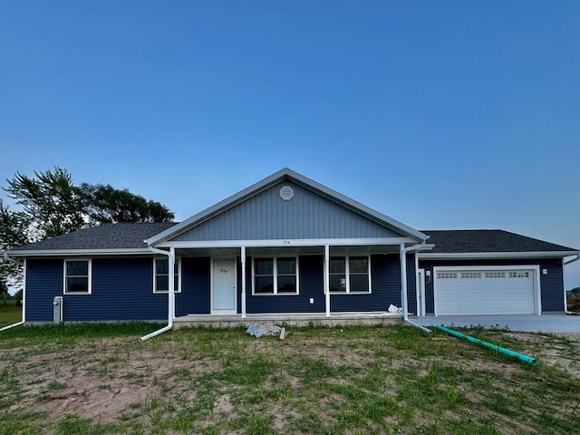 view of front facade featuring covered porch and a garage