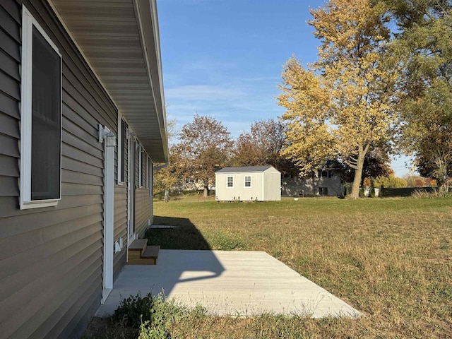 view of yard with a patio area and a storage unit