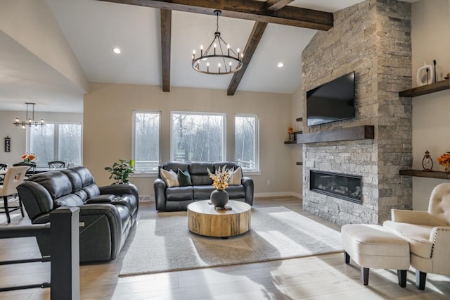 living room with light hardwood / wood-style floors, beam ceiling, a stone fireplace, and high vaulted ceiling