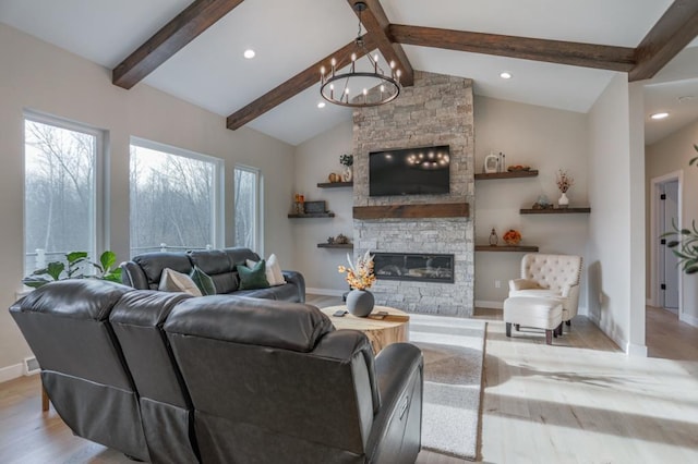 living room with a chandelier, lofted ceiling with beams, a fireplace, and light hardwood / wood-style floors