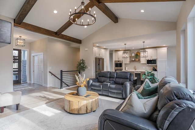 living room featuring beam ceiling, high vaulted ceiling, sink, and light wood-type flooring