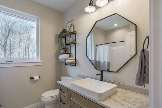 bathroom featuring toilet and vanity