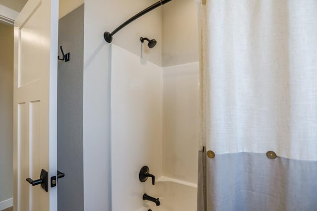 bathroom with shower / bath combo with shower curtain