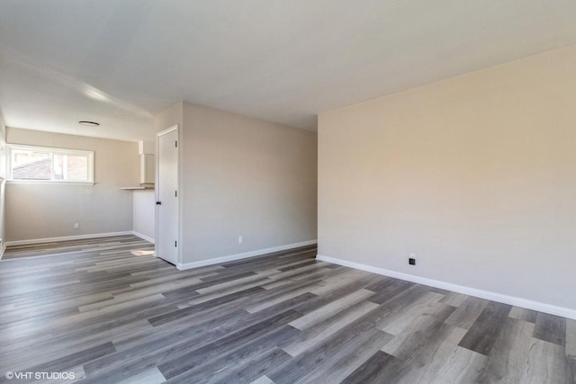 empty room with dark hardwood / wood-style flooring