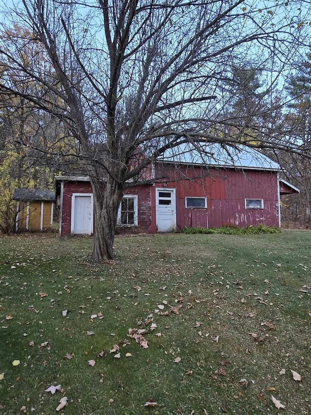 view of outbuilding with a yard