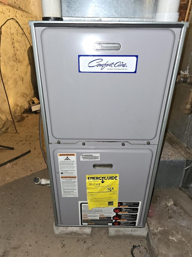 utility room featuring heating unit